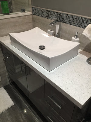 Bathroom custom vanity - shiny dark grey wall amount vanity, with quartz white top and acrylic sink.